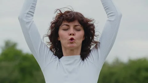 Mid shot of pretty lady doing breathing exercise with closed eyes. Sports Stock Footage 260825471