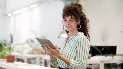 Mid-shot side view of beautiful young female entrepreneur using digital tablet Stock Footage 277954085