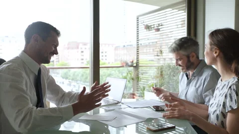 Mid-shot side view of cheerful couple signing real estate purchase deal and Stock Footage 277973066