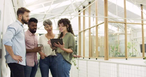 Mid-shot side view of diverse group of coworkers chatting in company hallway Stock Footage 277949774