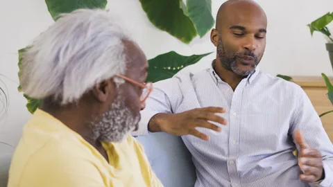 Mid-shot side view of diverse group of coworkers chatting in company hallway Stock Footage 278034384