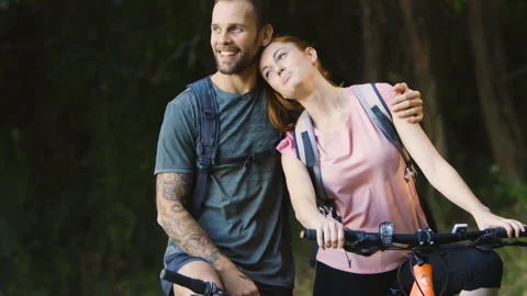 Mid-shot side view of relaxed group of coworkers going over details of marketing Stock Footage 278023456
