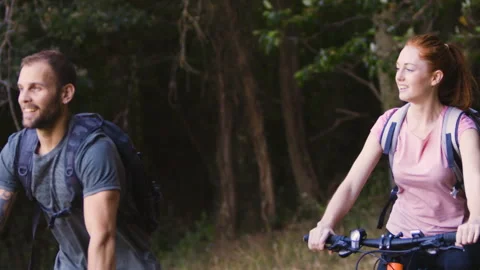 Mid-shot side view of relaxed group of coworkers going over details of marketing Stock Footage 278023493