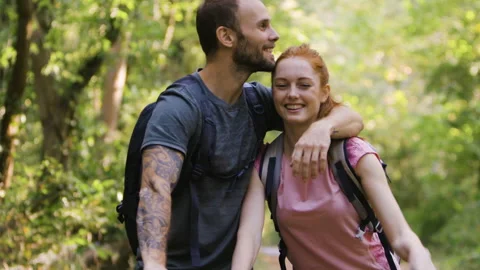 Mid-shot side view of relaxed group of coworkers going over details of marketing Stock Footage 278023871