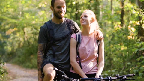 Mid-shot side view of relaxed group of coworkers going over details of marketing Stock Footage 278023881