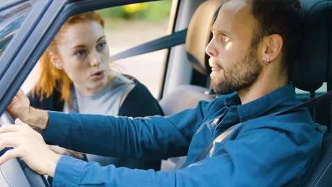 Mid-shot side view of relaxed group of coworkers going over details of marketing Stock Footage 278024602