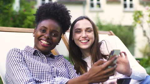 Mid-shot side view of relaxed group of coworkers going over details of marketing Stock Footage 278025439