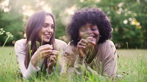Mid-shot side view of relaxed group of coworkers going over details of marketing Stock Footage 278026102