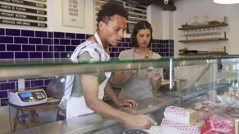 Mid-shot side view of two small business owners performing inventory check in Stock Footage 277964018