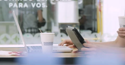 Mid-shot side view of two unidentified people drinking coffee from paper cups Stock Footage 277965348