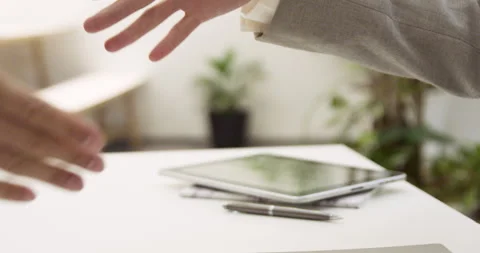 Mid-shot side view of unidentified people's hands shaking while reaching an Stock Footage 277950738