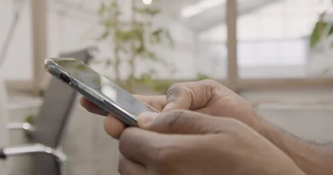 Mid-shot side view of unrecognizable person's hands holding cell phone and Stock Footage 277948537