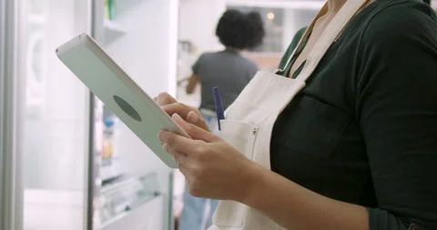 Mid-shot side view of unrecognizable woman's hands tapping and swiping on Stock Footage 277961060