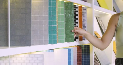 Mid-shot side view of unrecognizable person's hand showing mosaic tiles inside Stock Footage 277964067