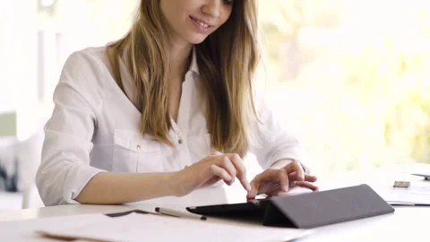 Mid-shot side view of unrecognizable woman's hands touching laptop's touchpad Video stock 277980636