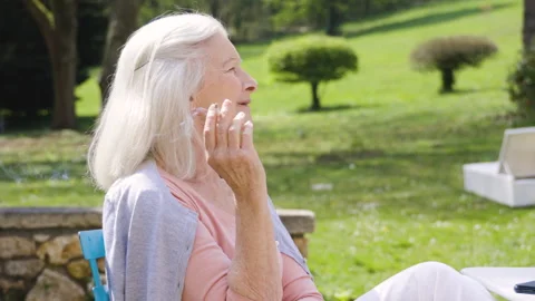 Mid-shot side view of unrecognizable person's hands holding cell phone and Stock Footage 278013052
