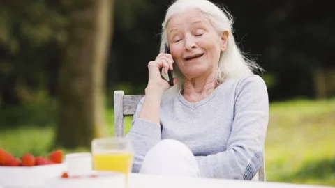 Mid-shot side view of unrecognizable person's hands holding cell phone and Stock Footage 278014555