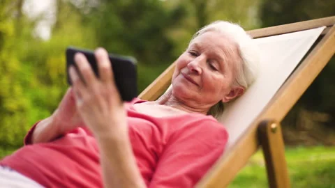 Mid-shot side view of unrecognizable person's hands holding cell phone and Stock Footage 278014917
