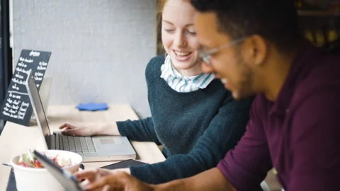 Mid-shot side view of young woman holding a digital tablet while checking text Stock Footage 278010197