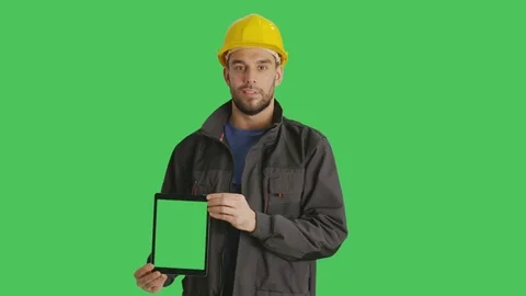 Mid Shot of a Smiling Working with Hard Hat on Holding Vertically Tablet Video stock 71263923