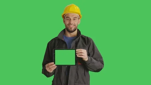 Mid Shot of a Smiling Working with Hard Hat on Holding Horizontally Tablet Video stock 71264023