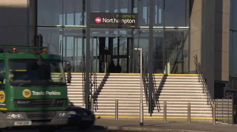 Mid shot of traffic past a train station in Northampton Stock Footage 53304749