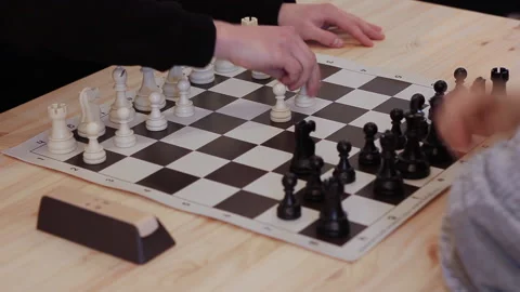 Mid shot of two men playing in speed chess on wooden table Stock Footage 205319300