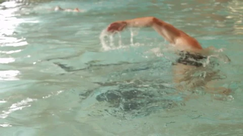 Mid shot of two swimmers in a pool passing each other Stock Footage 107626617