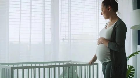 Mid shot video of pensive future mom in bedroom Stock Footage 131814478