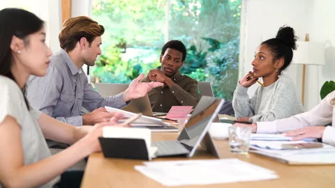 Mid-shot view of diverse group of colleagues exchanging ideas for new project Stock Footage 278053412