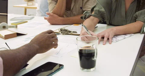 Mid-shot view of unrecognizable people's hands writing and taking notes inside Stock Footage 277949880