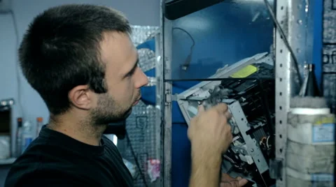 Mid shot Worker clean electronics with compressed air Stock Footage 65511837