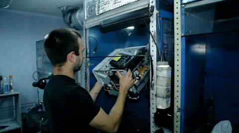 Mid shot Worker clean electronics with compressed air Stock Footage 65511896