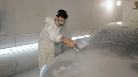 Mid shot Worker paints a car in white colour Stock Footage 65757833