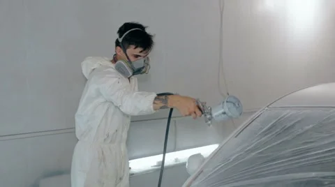 Mid shot Worker paints a car in white colour Stock Footage 65757939