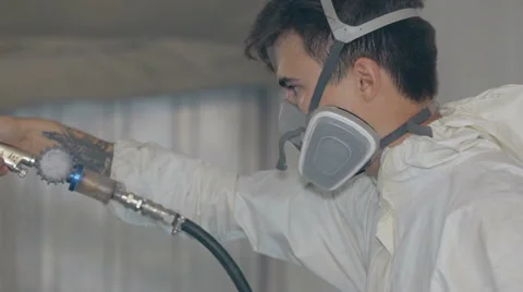 Mid shot Worker paints a car in white colour Stock Footage 65758054