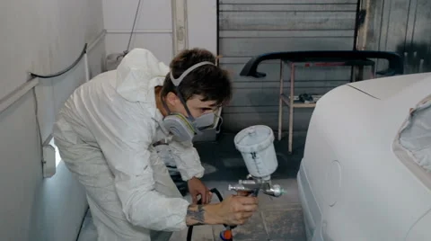 Mid shot Worker paints a car in white colour Stock Footage 65758087