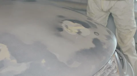 Mid shot Worker paints a car in white colour Stock Footage 65758111