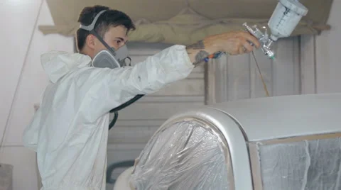 Mid shot Worker paints a car in white colour Stock Footage 65758140