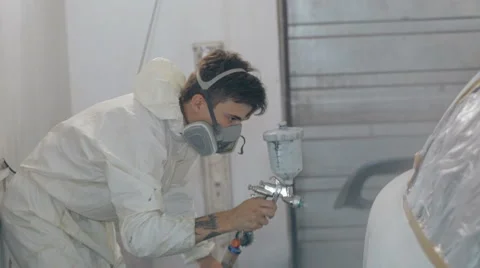 Mid shot Worker paints a car in white colour Stock Footage 65758169