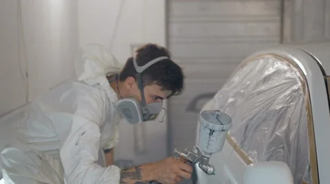 Mid shot Worker paints a car in white colour Stock Footage 65758221