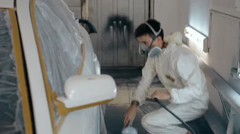Mid shot Worker paints a car in white colour Stock Footage 65758286