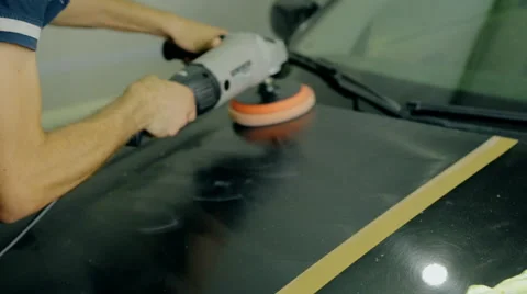 Mid shot Worker polish black car with special tools Stock Footage 65758656