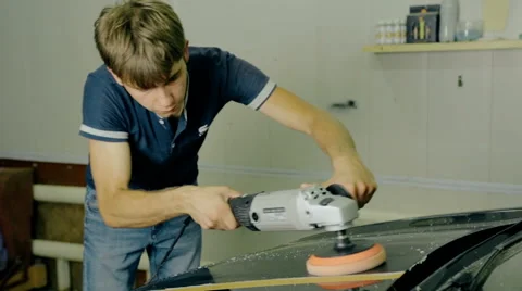 Mid shot Worker polish black car with special tools Stock Footage 65758683