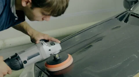 Mid shot Worker polish black car with special tools Stock Footage 65758754