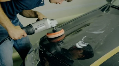 Mid shot Worker polish black car with special tools Stock Footage 65758954
