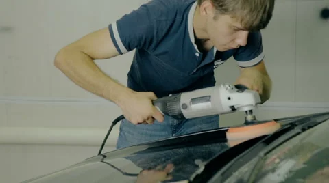 Mid shot Worker polish black car with special tools Stock Footage 65759050