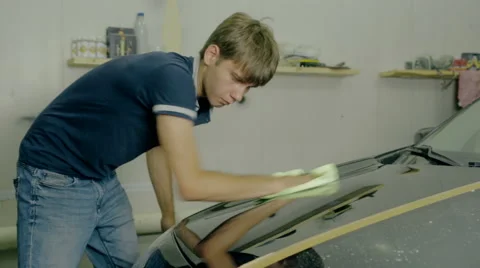Mid shot Worker polish black car with special tools Stock Footage 65759120