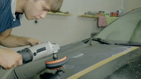 Mid shot Worker polish black car with special tools Stock Footage 65760096