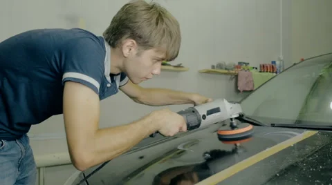 Mid shot Worker polish black car with special tools Stock Footage 65760098